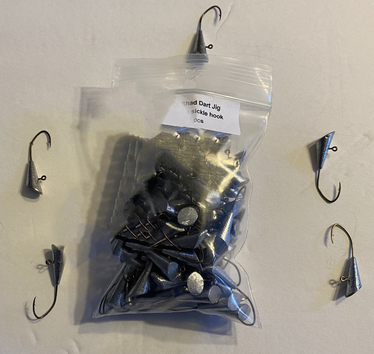 100pcs unpainted Shad Dart jigs 1/64oz, 1/32,1/20, 1/16oz, and 1/8oz weights Hook sizes vary on weight bronze sickle hook.