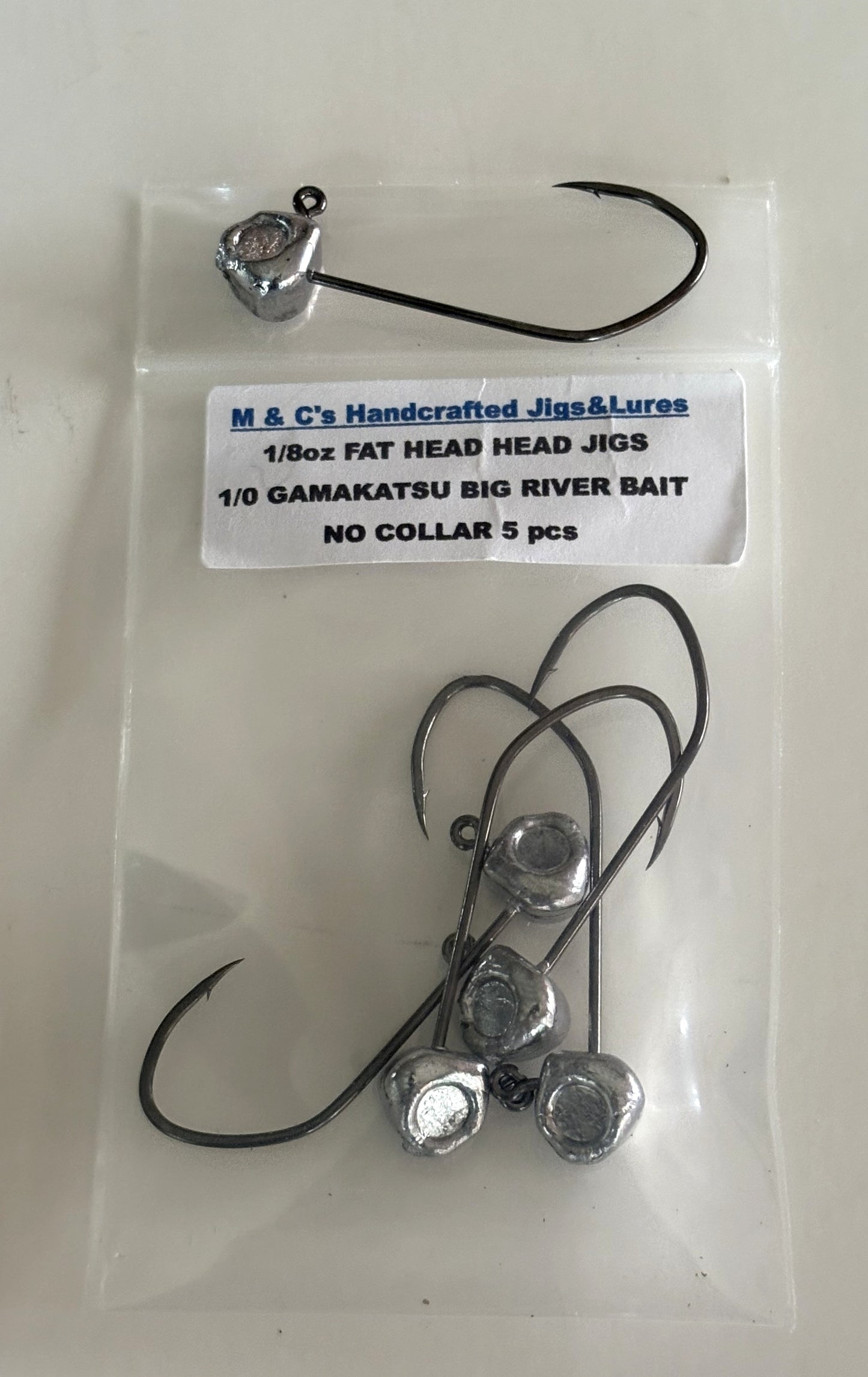 5 Hand made 1/8oz Fat Head jigs heads with a 1/0 or 2/0 Gamakatsu Big River hook.